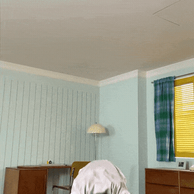 Man In White Shirt Jumping In Room GIF