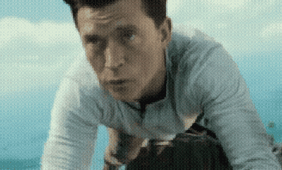 Man In White Shirt Kneeling Under Blue Sky GIF