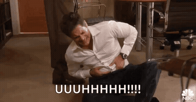 Man In White Shirt Laughing Holding Stomach GIF