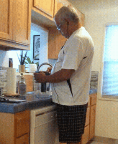 Man In White Shirt Looking At Phone GIF