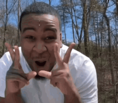 Man In White Shirt Making Peace Sign GIF