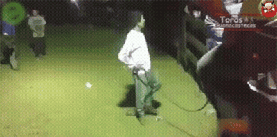 Man In White Shirt Next To Fence Saying Toros GIF