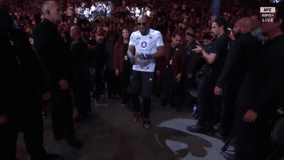 Man In White Shirt Number 18 Walking Through Crowd GIF