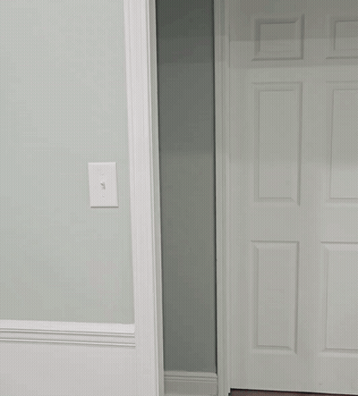 Man In White Shirt Peeking Out Of Doorway GIF