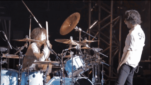 Man In White Shirt Playing Drums GIF