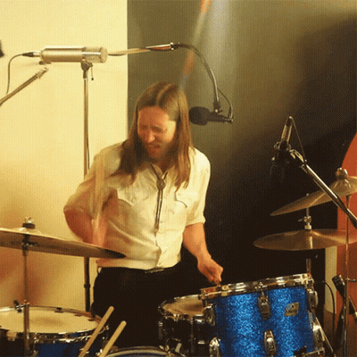 Man In White Shirt Playing Drums GIF
