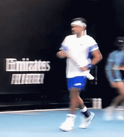 Man In White Shirt Playing Tennis In Front Of Emirates Sign GIF
