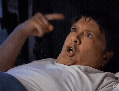 Man In White Shirt Pointing At Head GIF