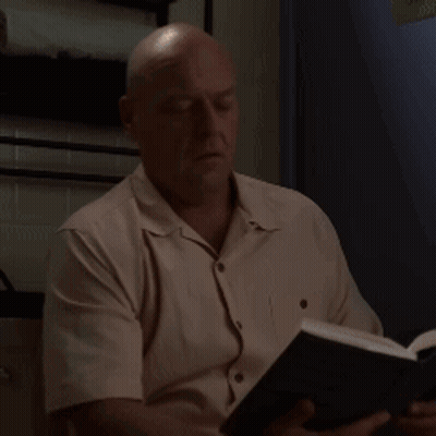 Man In White Shirt Reading Book With Eyes Closed GIF
