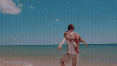 Man In White Shirt Running On Beach GIF