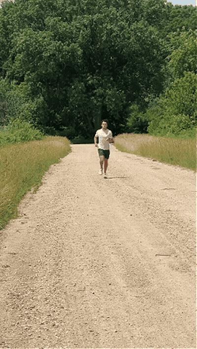 Man In White Shirt Running On Dirt Road GIF
