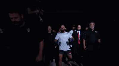 Man In White Shirt Running Through Crowd GIF