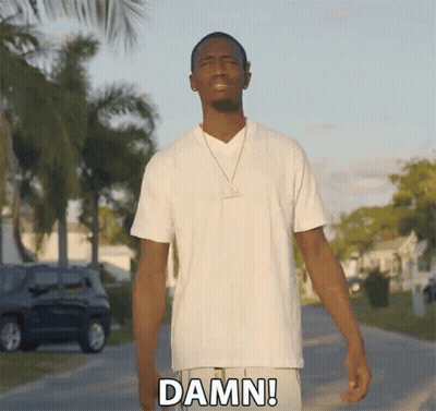 Man In White Shirt Saying Damn Walking Down Street GIF
