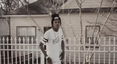 Man In White Shirt Saying Delta In Front Of House GIF