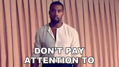 Man In White Shirt Saying Don't Pay Attention To In Front Of Pink Curtain GIF