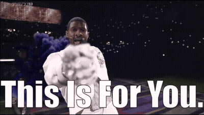 Man In White Shirt Saying This Is For You In Front Of Stadium GIF