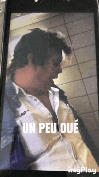 Man In White Shirt Saying Un Peu Oue GIF