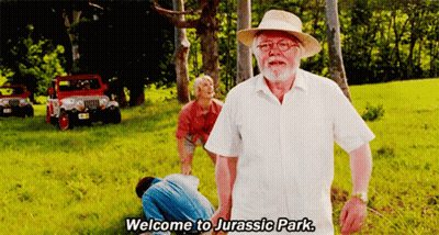 Man In White Shirt Saying Welcome To Jurassic Park GIF