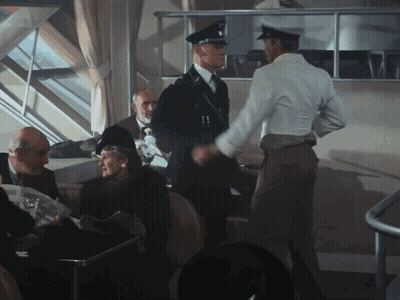 Man In White Shirt Shaking Hands With Man In Black Uniform GIF