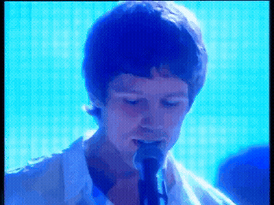 Man In White Shirt Singing Into Microphone GIF