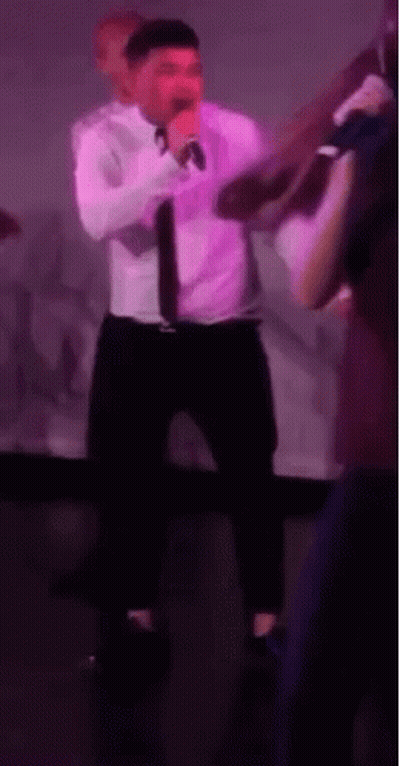 Man In White Shirt Singing Into Microphone GIF
