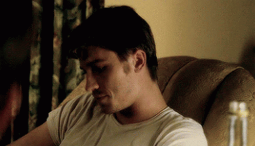 Man In White Shirt Sitting And Looking Down GIF
