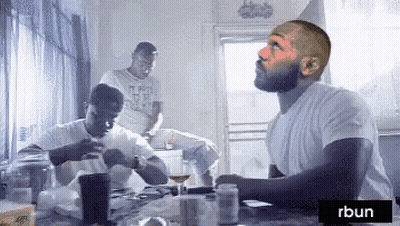 Man In White Shirt Sitting At Table GIF