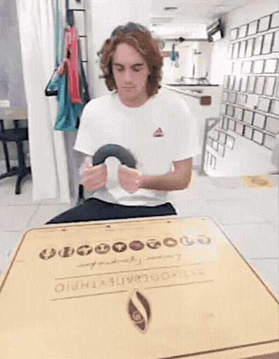 Man In White Shirt Sitting At Table With Box Saying 00000 GIF