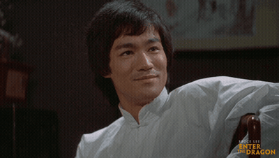 Man In White Shirt Sitting Enter The Dragon GIF