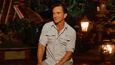 Man In White Shirt Sitting In Front Of Lamp GIF