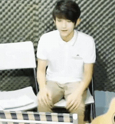 Man In White Shirt Sitting Next To Guitar GIF