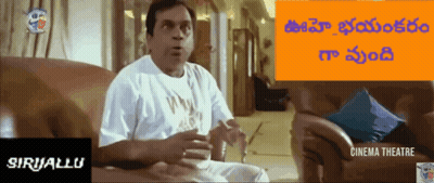 Man In White Shirt Sitting On Couch In Front Of Cinema Sign GIF