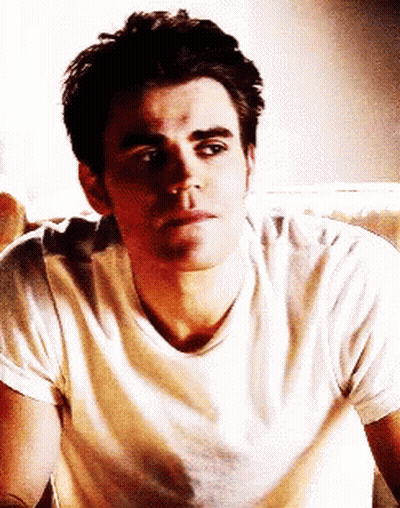 Man In White Shirt Sitting On Couch Looking At Camera GIF