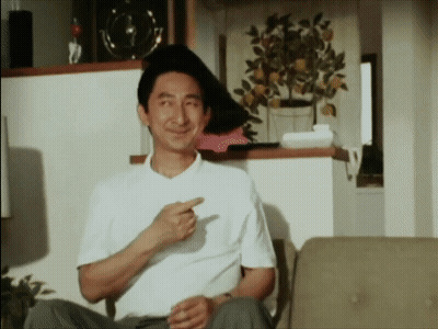 Man In White Shirt Sitting On Couch Pointing GIF