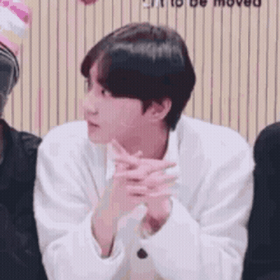 Man In White Shirt Sitting With Hands Folded GIF