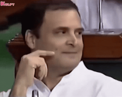Man In White Shirt Smiling Hand On Chin GIF