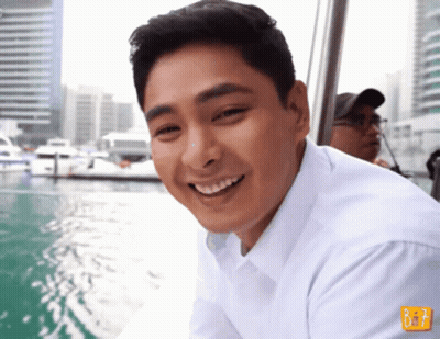 Man In White Shirt Smiling In Front Of B & T Sign GIF