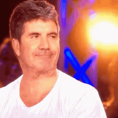 Man In White Shirt Smiling In Front Of Blue Cross GIF