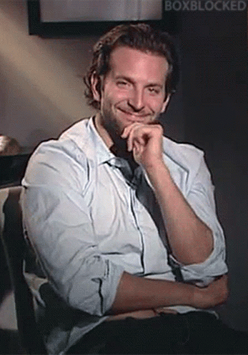 Man In White Shirt Smiling With Hand On Chin GIF