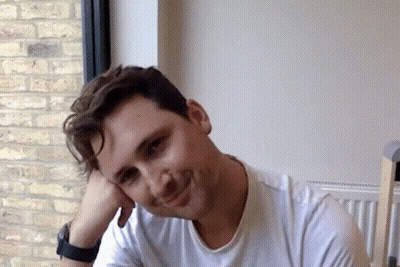 Man In White Shirt Smiling With Hand On Face GIF