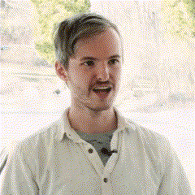 Man In White Shirt Smiling With Microphone GIF