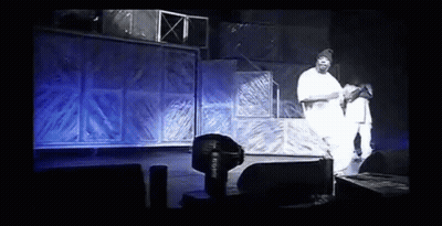 Man In White Shirt Standing At Microphone GIF