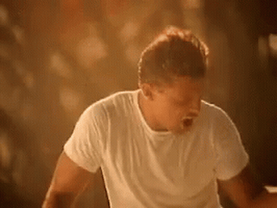 Man In White Shirt Standing Before Crowd GIF