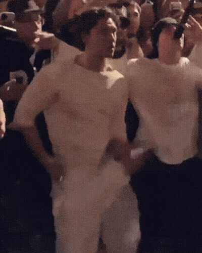 Man In White Shirt Standing Before Crowd GIF