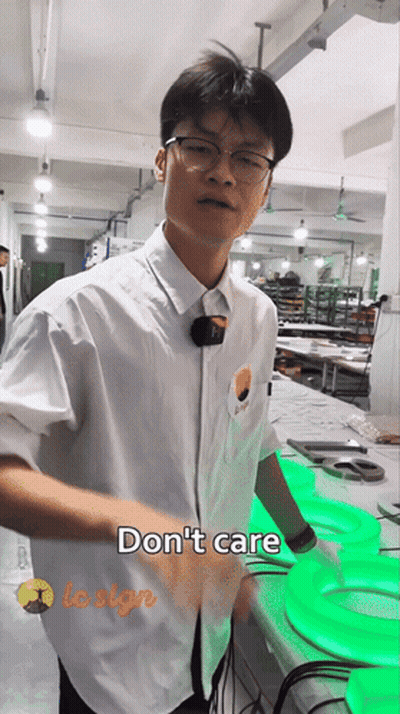 Man In White Shirt Standing Before Do Not Care Sign GIF
