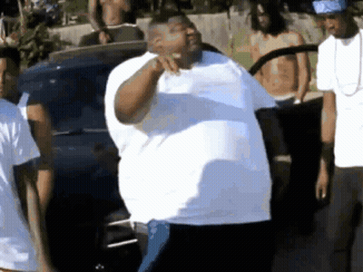 Man In White Shirt Standing Before Group GIF