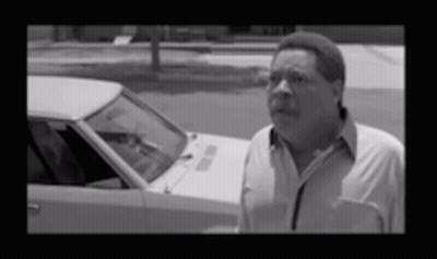 Man In White Shirt Standing By Car GIF