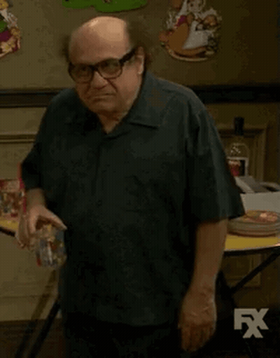 Man In White Shirt Standing By Couch And Star Wars Poster GIF
