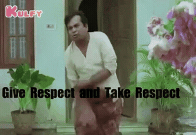 Man In White Shirt Standing By Door With Flower Pots GIF