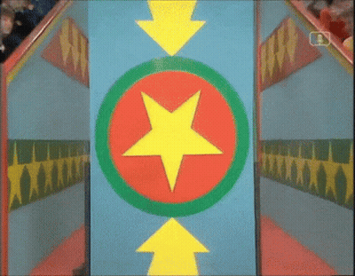 Man In White Shirt Standing In Colorful Room With NBC Sign GIF